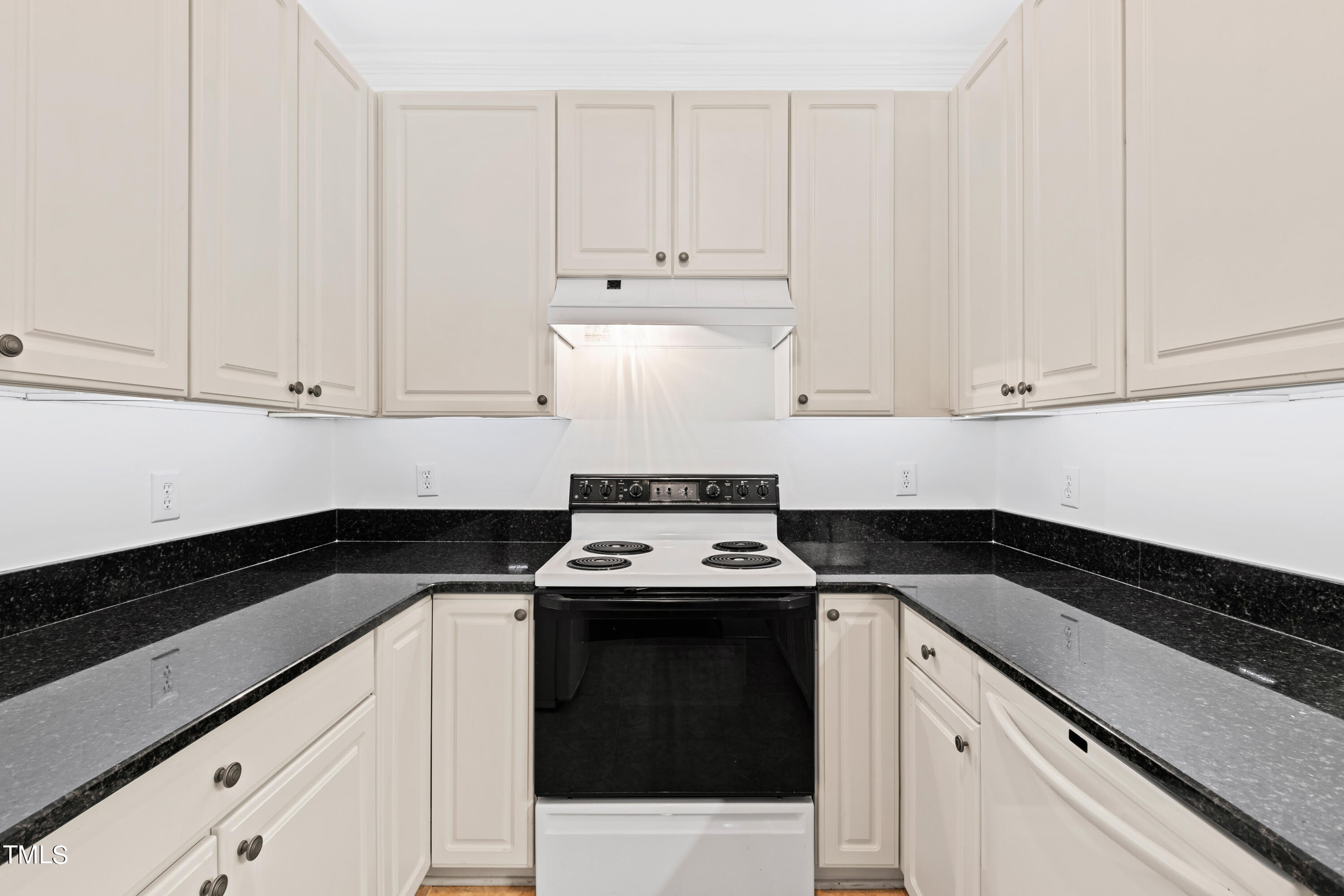 3834 Carnegie Lane Raleigh, NC 27612 - Photo 7 of 38 a kitchen with granite countertop white cabinets and black appliances