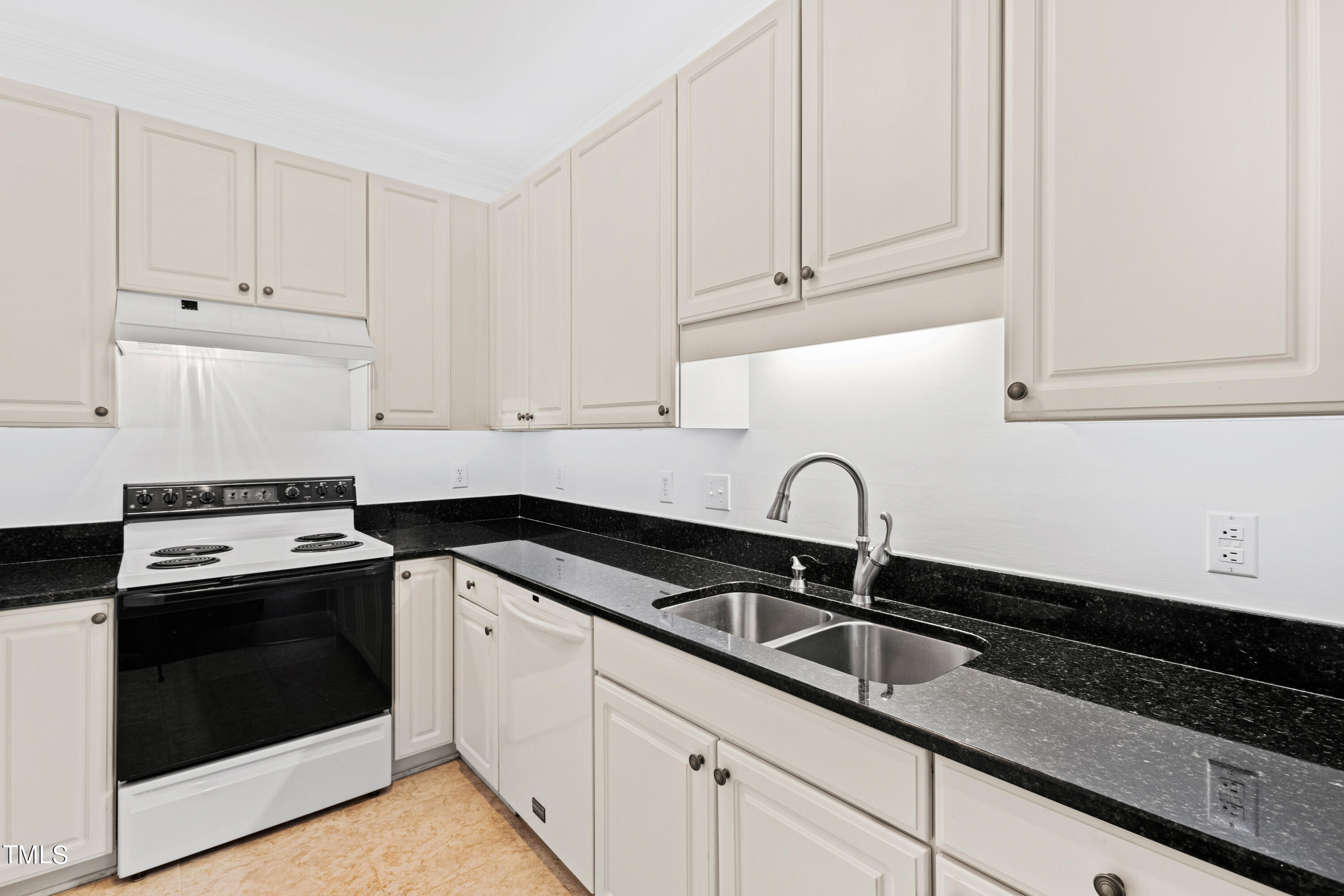 3834 Carnegie Lane Raleigh, NC 27612 - Photo 9 of 38 a kitchen with granite countertop white cabinets and sink