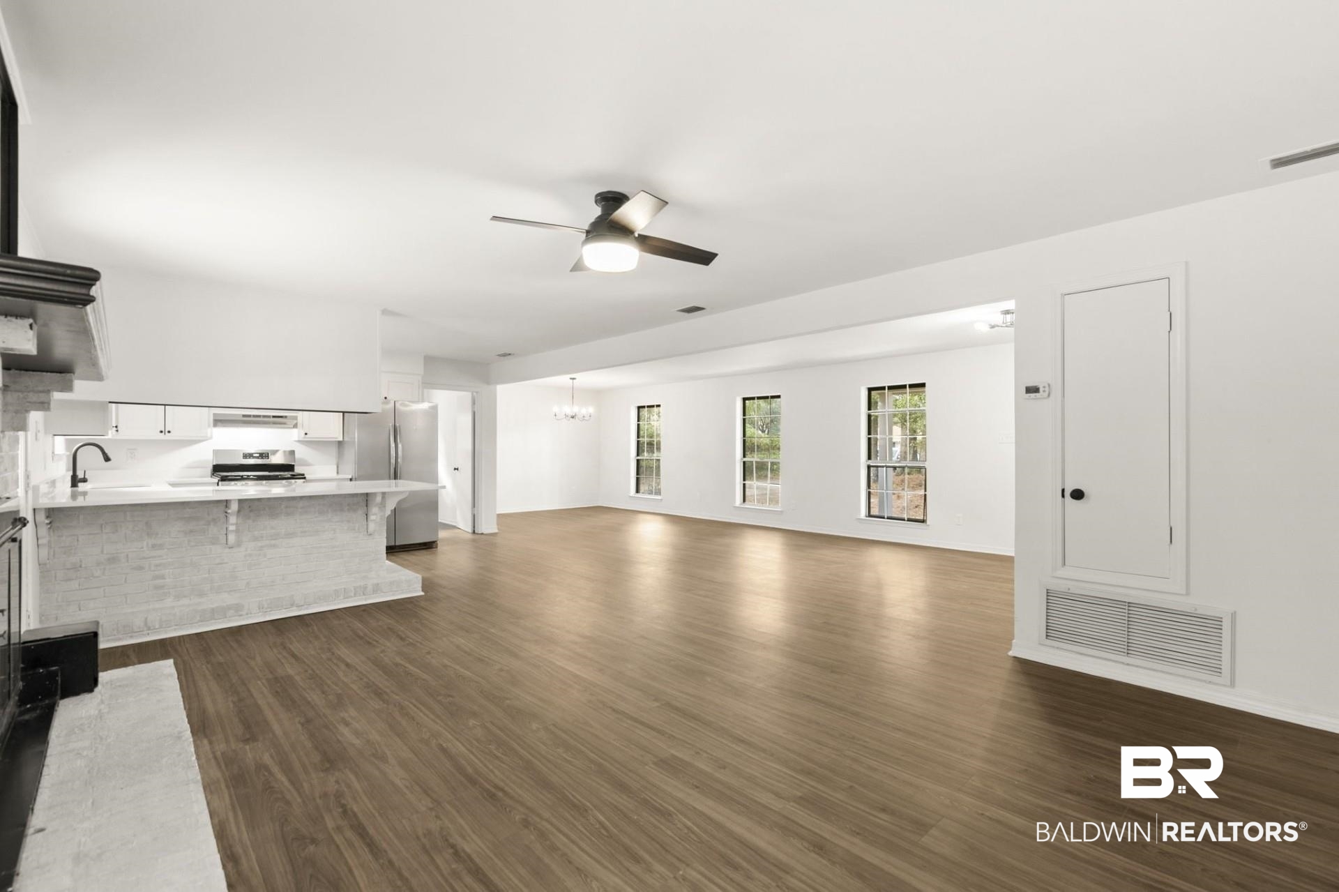 3270 Graham Road North Mobile, AL 36618 - Photo 10 of 54 Unfurnished living room featuring dark wood-type flooring and ceiling fan with notable chandelier