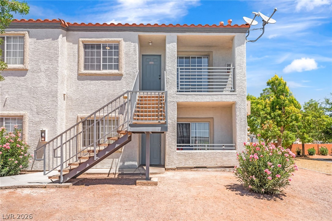 3318 North Decatur Boulevard, Unit 2152 Las Vegas, NV 89130 - Photo 1 of 58 A two-story residence with a stucco facade and tile roof presents inviting balconies and external stair access.