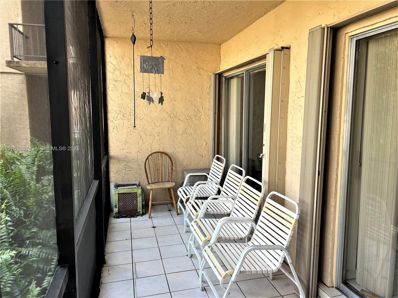 8401 Southwest 107th Avenue, Unit 121E Miami, FL 33173 - Photo 11 of 19 a bedroom with a bed and a dresser next to a window