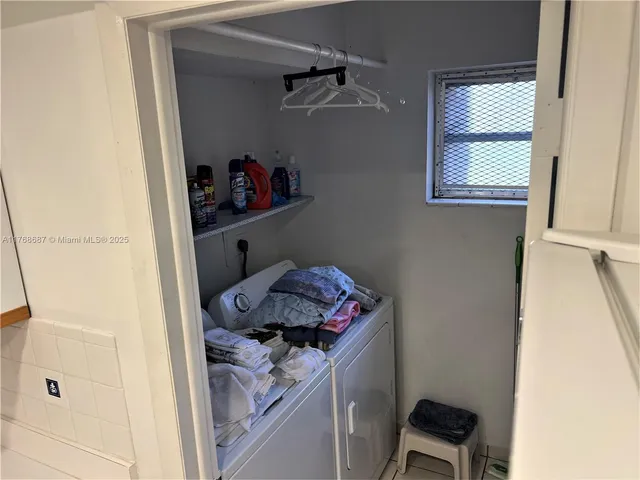 a view of storage and utility room with a window