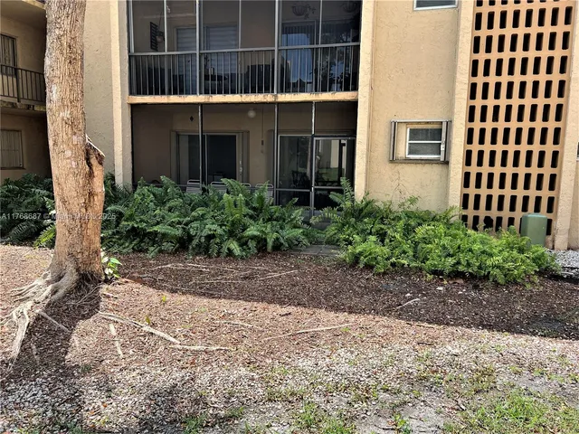 a view of a building with a yard