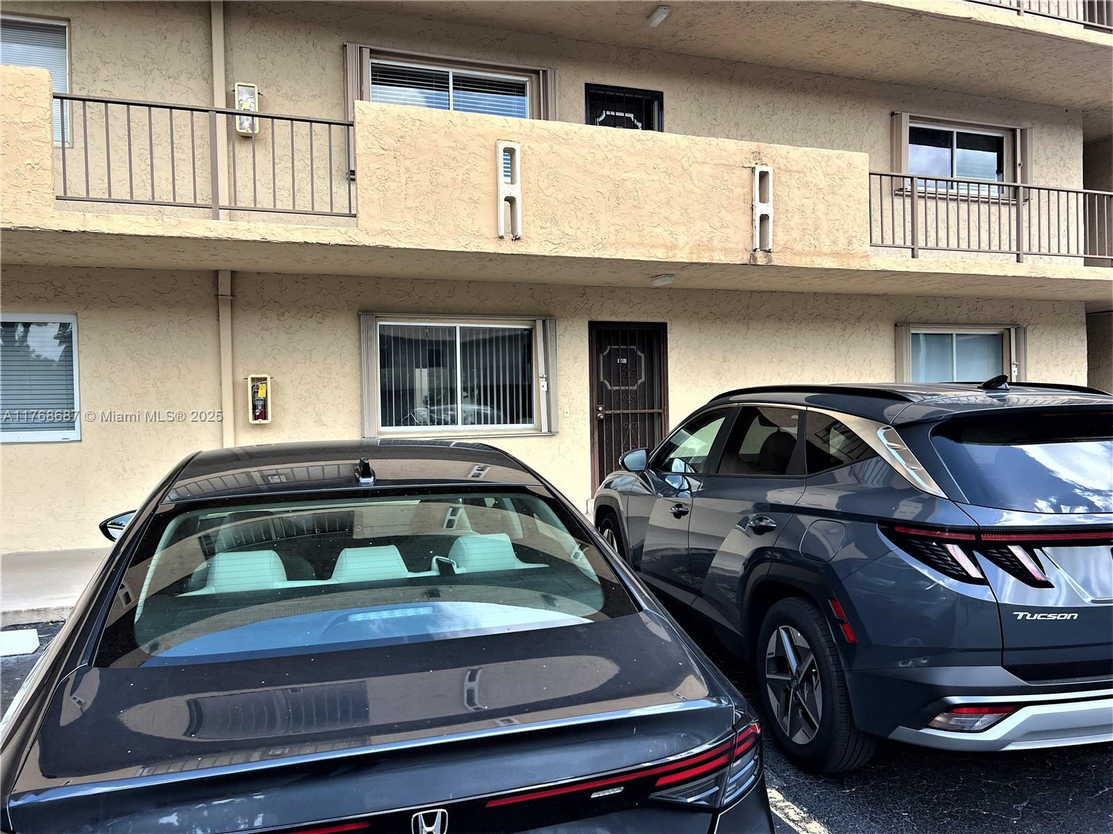 8401 Southwest 107th Avenue, Unit 121E Miami, FL 33173 - Photo 18 of 19 a view of car parked in front of building