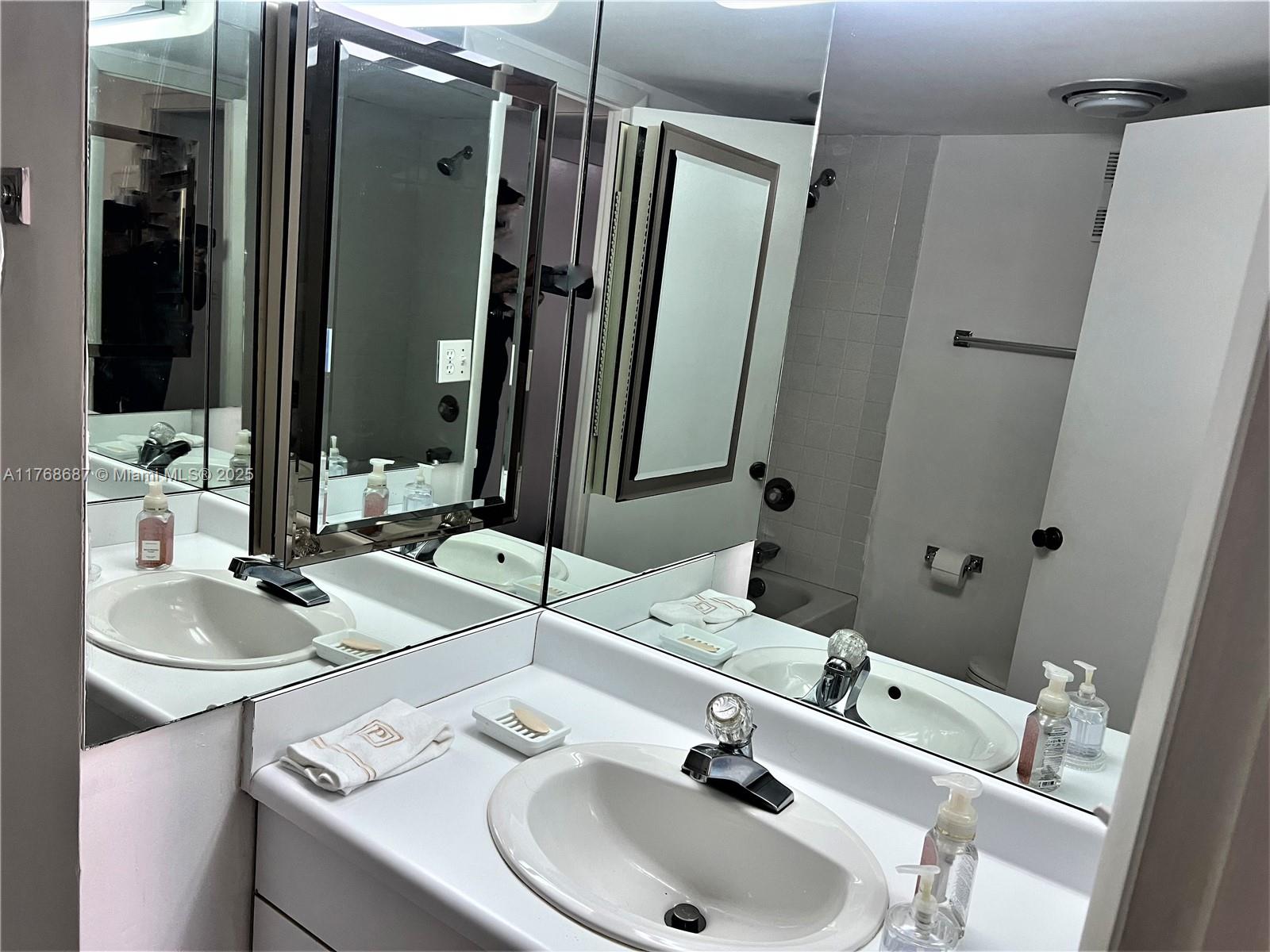 8401 Southwest 107th Avenue, Unit 121E Miami, FL 33173 - Photo 7 of 19 a bathroom with a sink and a mirror