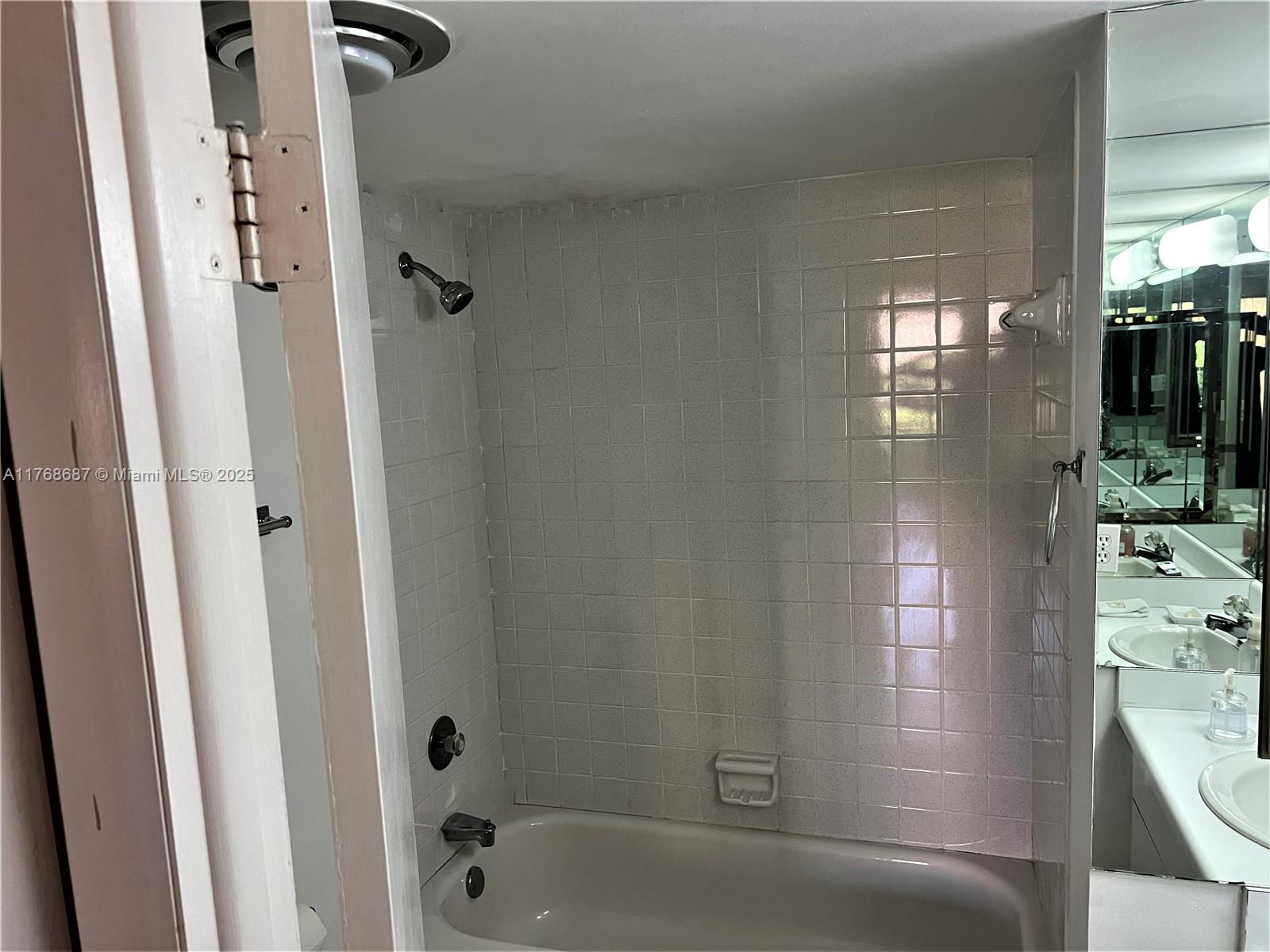 8401 Southwest 107th Avenue, Unit 121E Miami, FL 33173 - Photo 8 of 19 a bathroom with a shower
