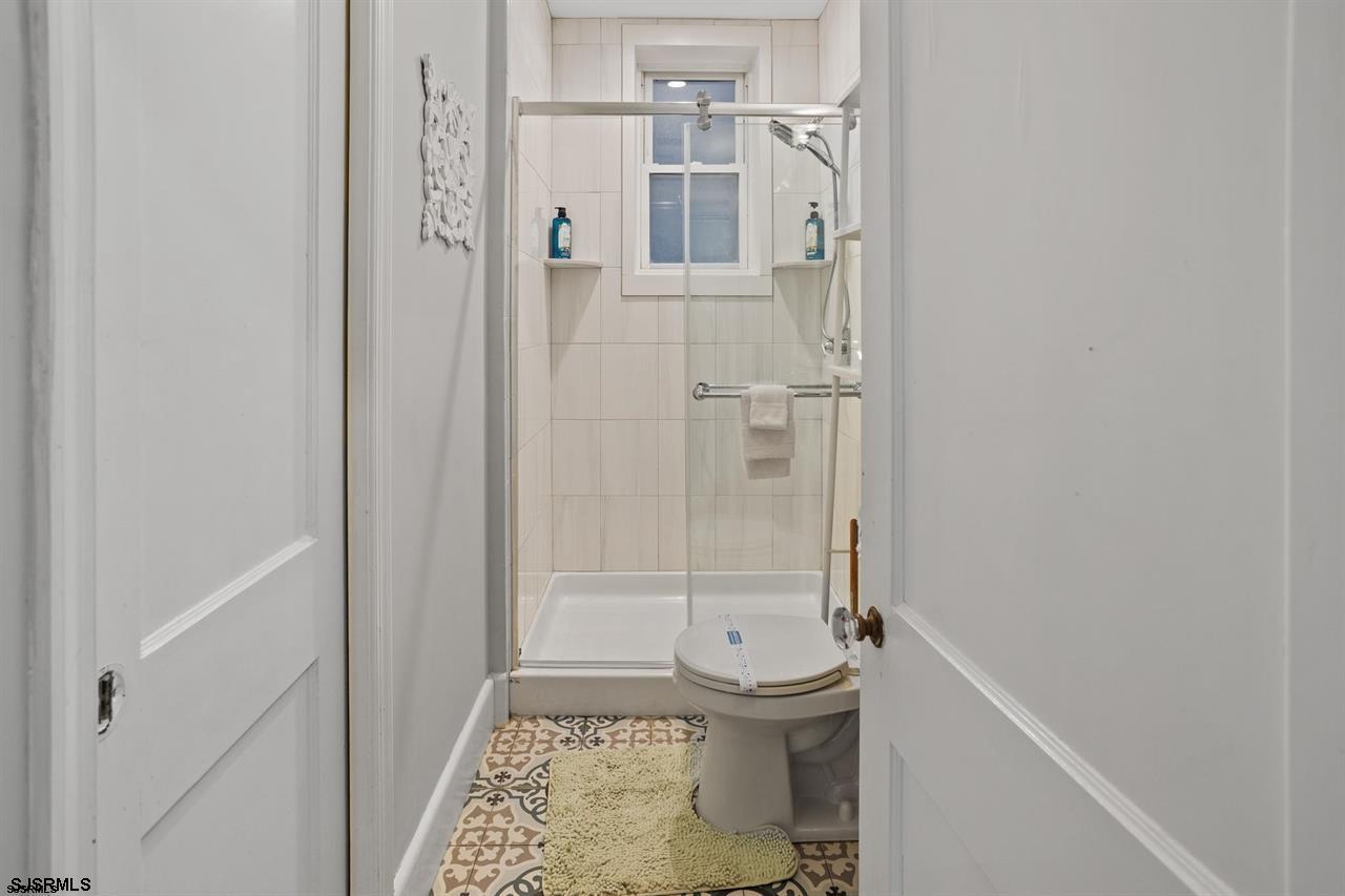 114 South Raleigh Avenue Atlantic City, NJ 08401 - Photo 17 of 52 a bathroom with a sink a toilet and shower