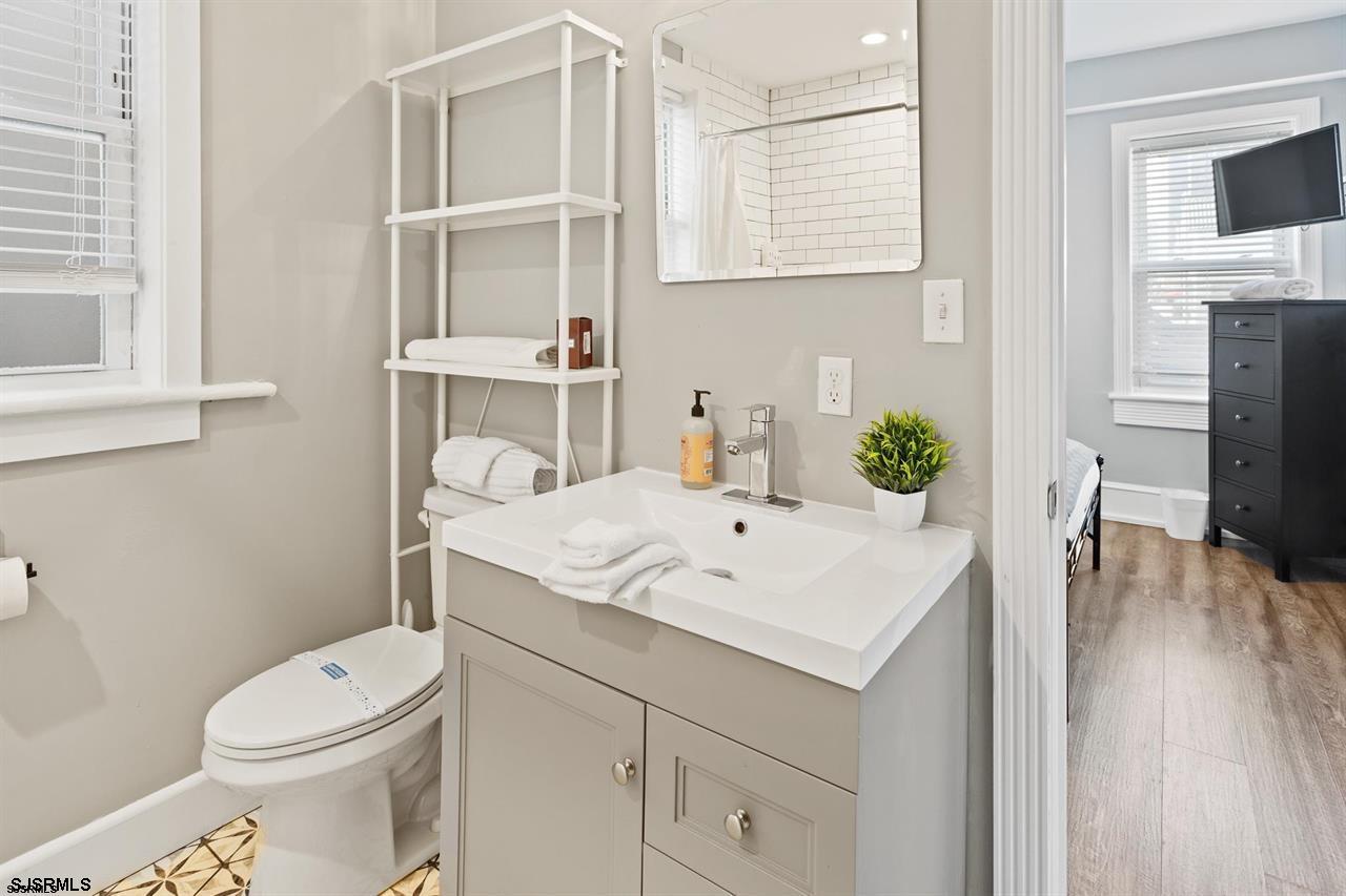 114 South Raleigh Avenue Atlantic City, NJ 08401 - Photo 21 of 52 a view of bathroom with a sink toilet and a mirror