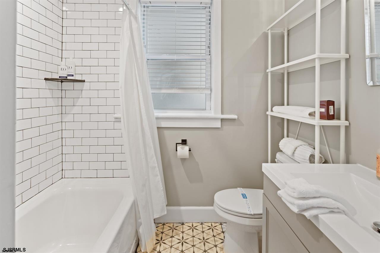114 South Raleigh Avenue Atlantic City, NJ 08401 - Photo 22 of 52 a bathroom with a sink a toilet and shower