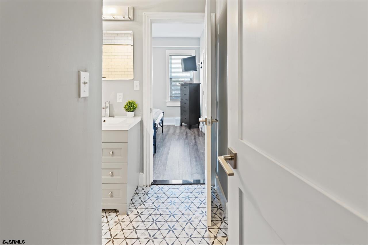 114 South Raleigh Avenue Atlantic City, NJ 08401 - Photo 23 of 52 a view of a hallway with windows and cabinet