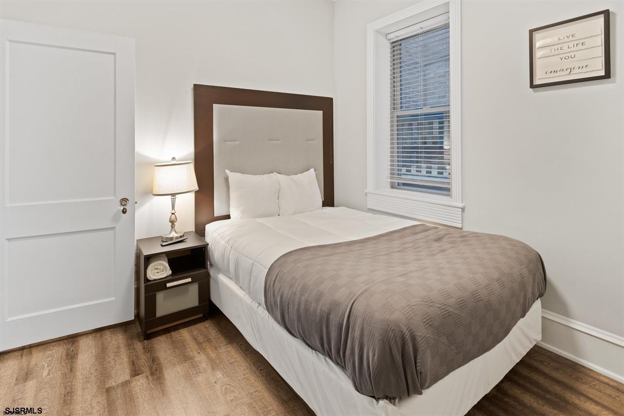 114 South Raleigh Avenue Atlantic City, NJ 08401 - Photo 28 of 52 a bed sitting in a bedroom next to a window