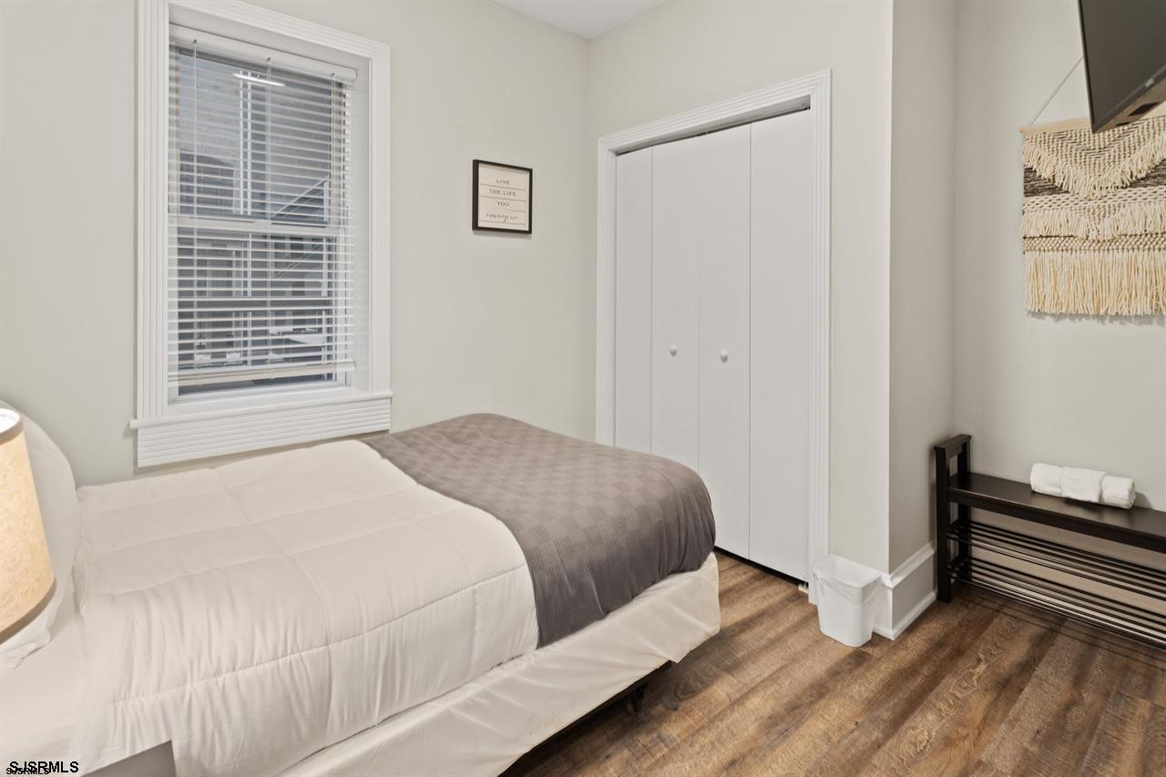 114 South Raleigh Avenue Atlantic City, NJ 08401 - Photo 29 of 52 a bedroom with a bed and a flat tv screen on a dresser