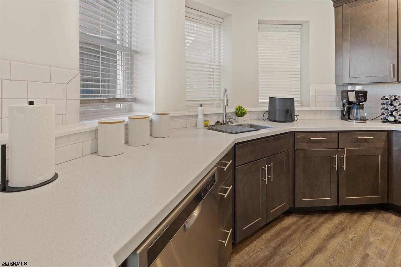114 South Raleigh Avenue Atlantic City, NJ 08401 - Photo 35 of 52 a kitchen with a sink a stove cabinets and a wooden floor