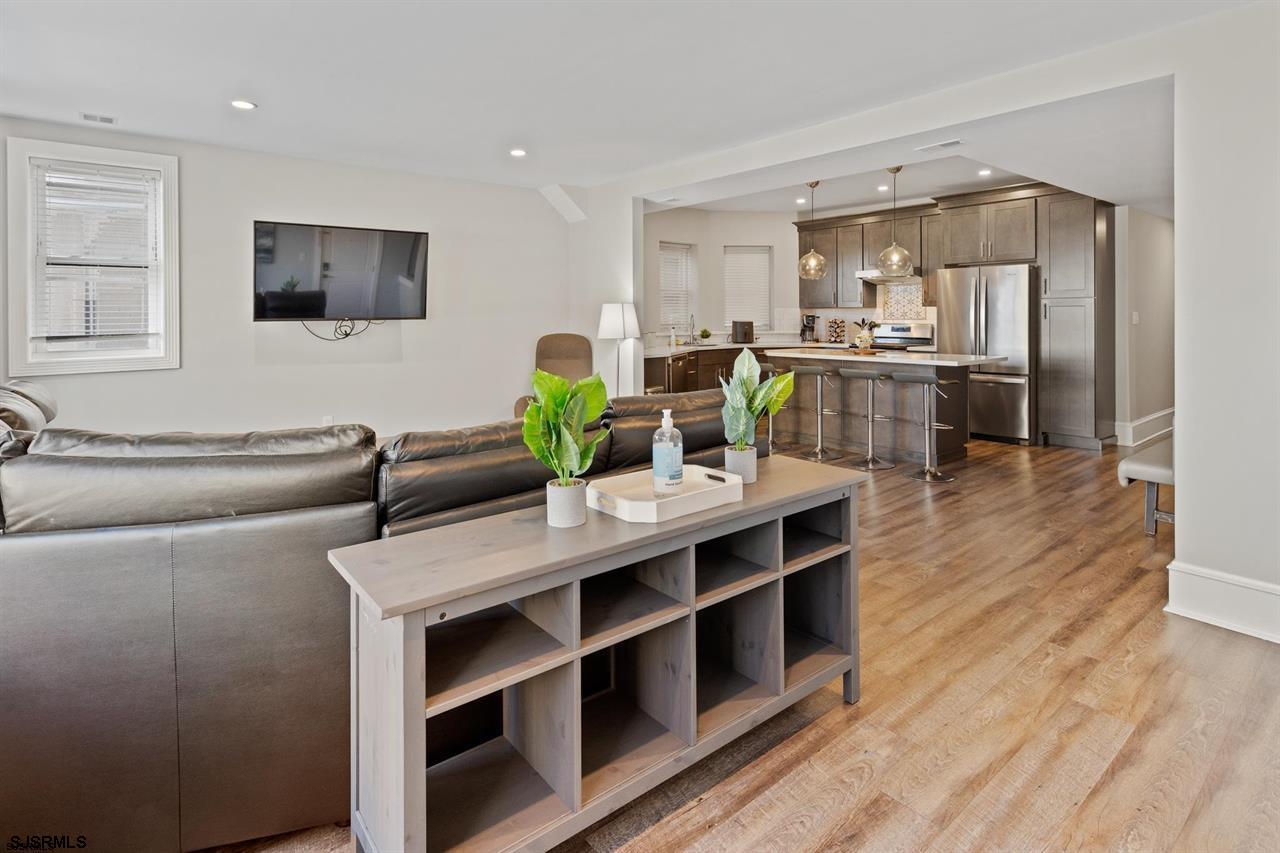 114 South Raleigh Avenue Atlantic City, NJ 08401 - Photo 42 of 52 a living room with stainless steel appliances kitchen island granite countertop a cabinets wooden floor and a view of kitchen