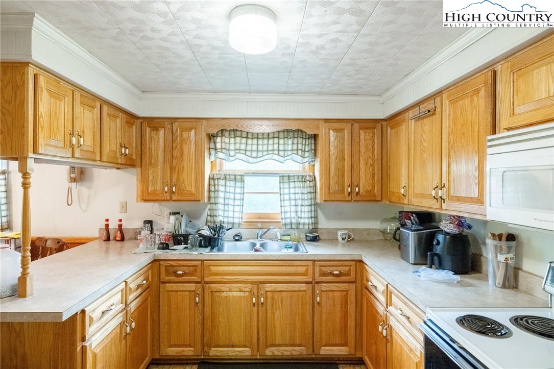 4690 3 Top Road Todd, NC 28684 - Photo 12 of 49 a kitchen with stainless steel appliances granite countertop a sink a stove and a refrigerator