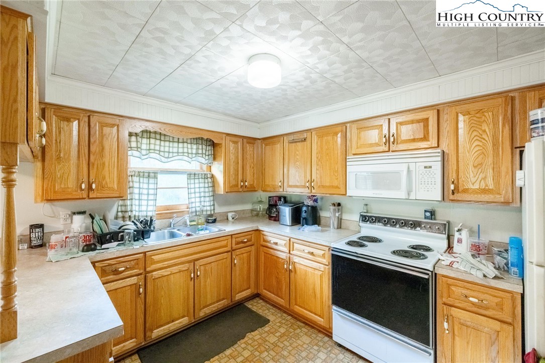 4690 3 Top Road Todd, NC 28684 - Photo 13 of 49 a kitchen with a sink stove top oven and cabinets