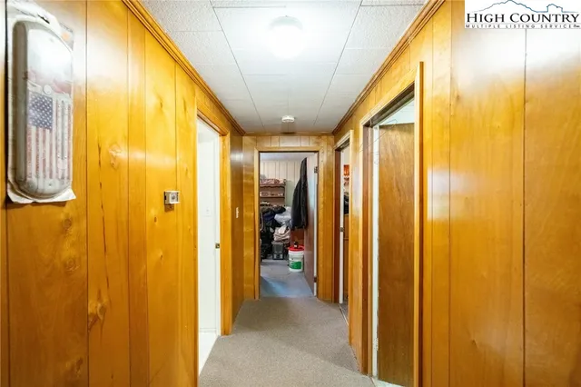 a view of a hallway with furniture and chandelier