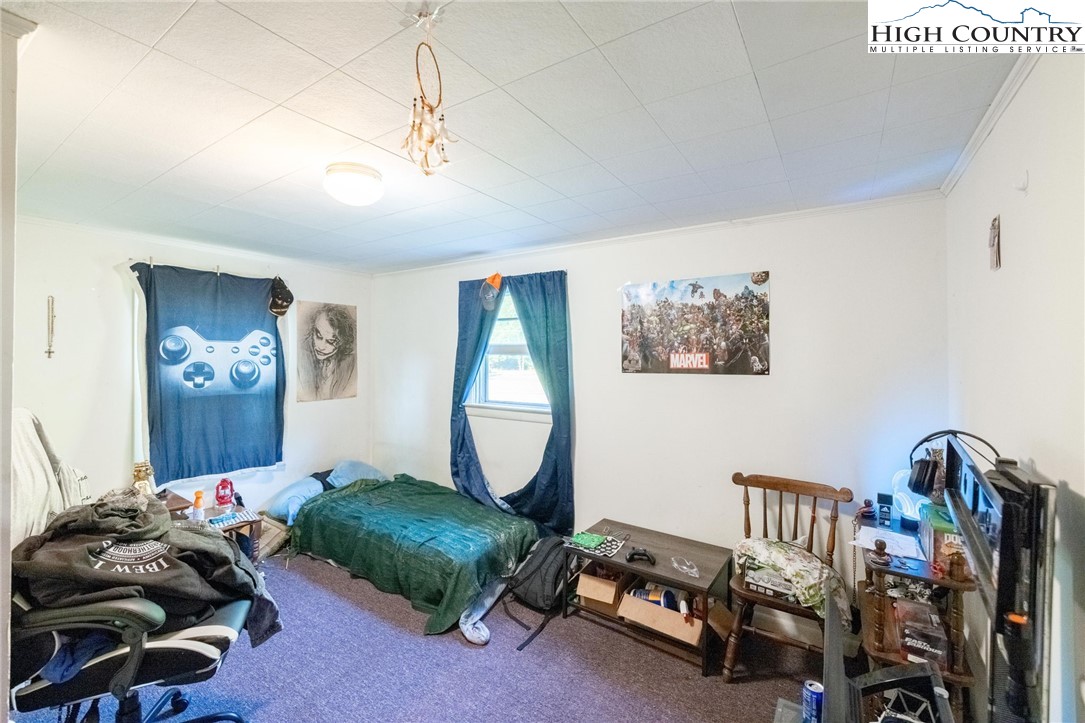 4690 3 Top Road Todd, NC 28684 - Photo 17 of 49 a bedroom with furniture and a gym equipment