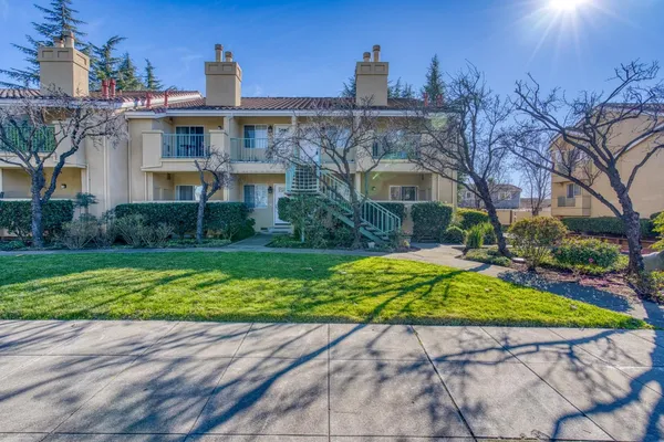 a house with green field in front of it