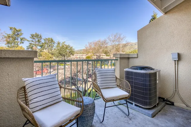 a view of a balcony with chairs