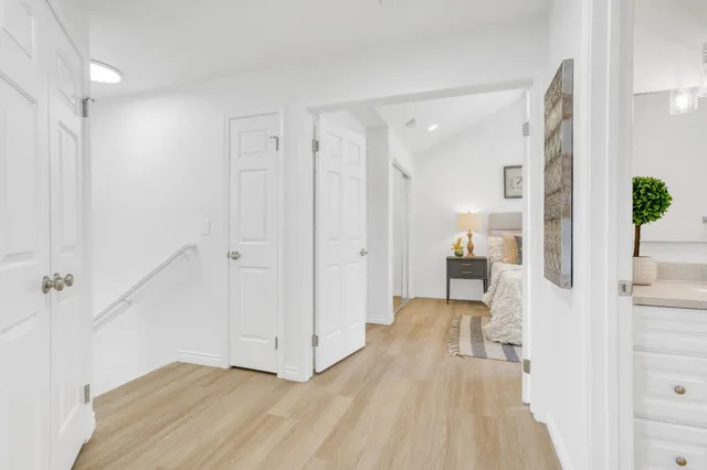 a view of a bedroom with wooden floor and furniture