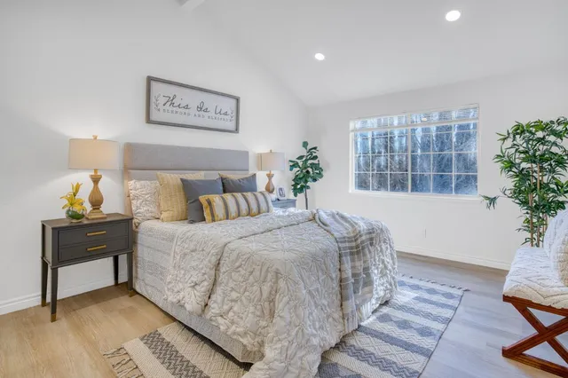 a spacious bedroom with a bed and window