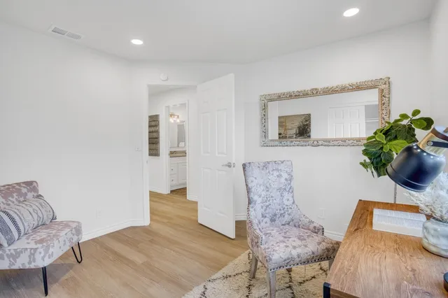 a living room with furniture and a potted plant