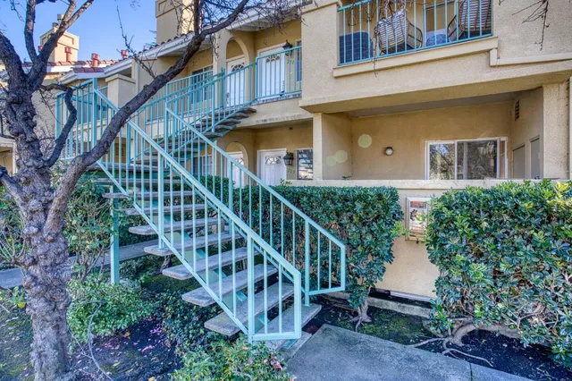 a view of a house with brick walls and flower plants