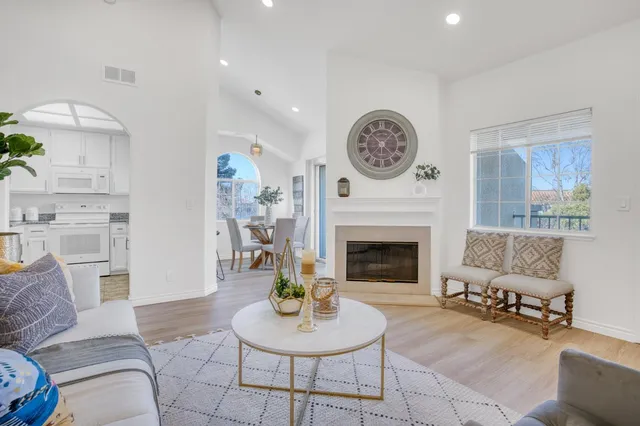 a living room with furniture a clock and a fireplace