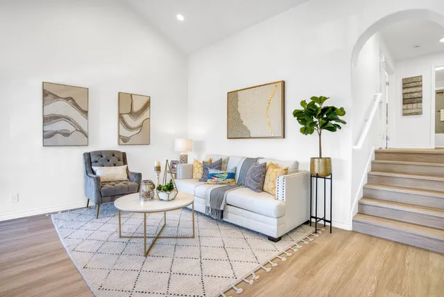 a living room with furniture and a potted plant