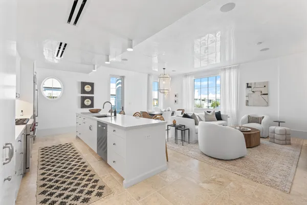 a large living room with white cabinets