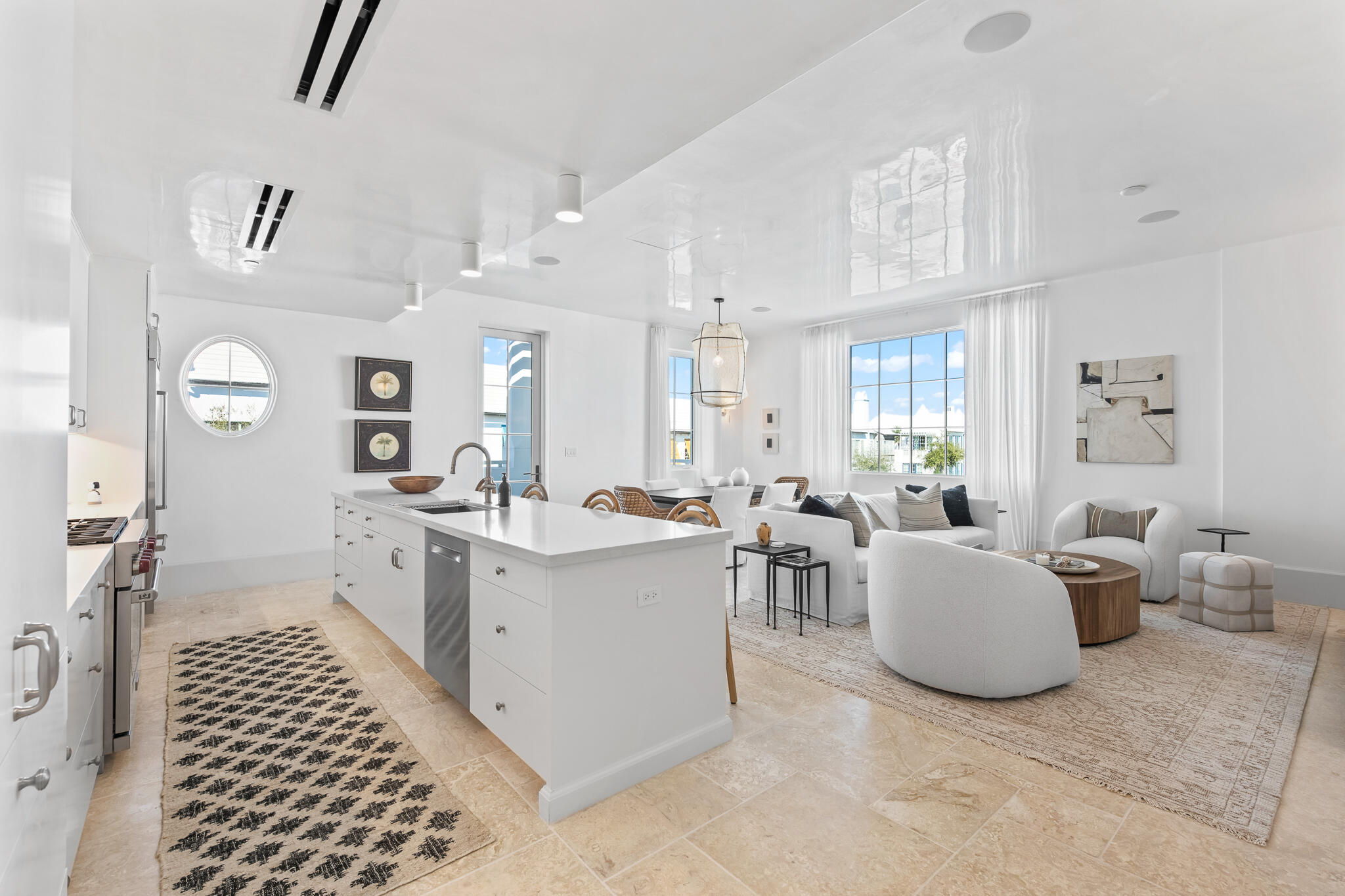 a large living room with white cabinets