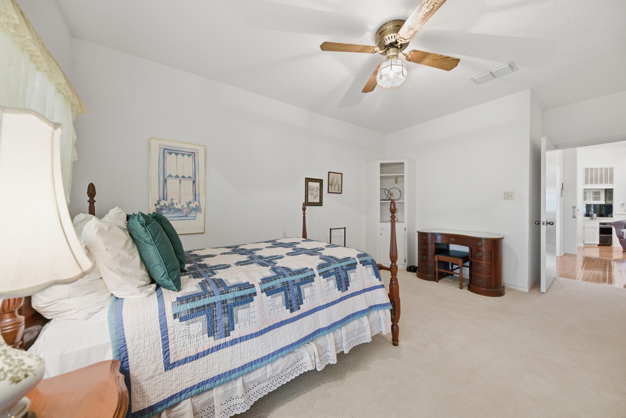 1552 Holub Road Schulenburg, TX 78956 - Photo 33 of 35 Carpeted bedroom features a classic wooden bed frame and a ceiling fan, offering a tranquil retreat.