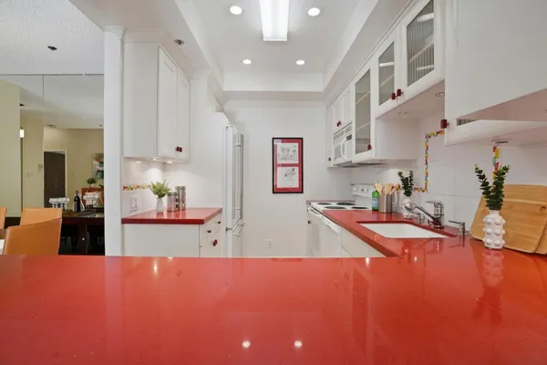 a kitchen with stainless steel appliances granite countertop a sink refrigerator stove and cabinets