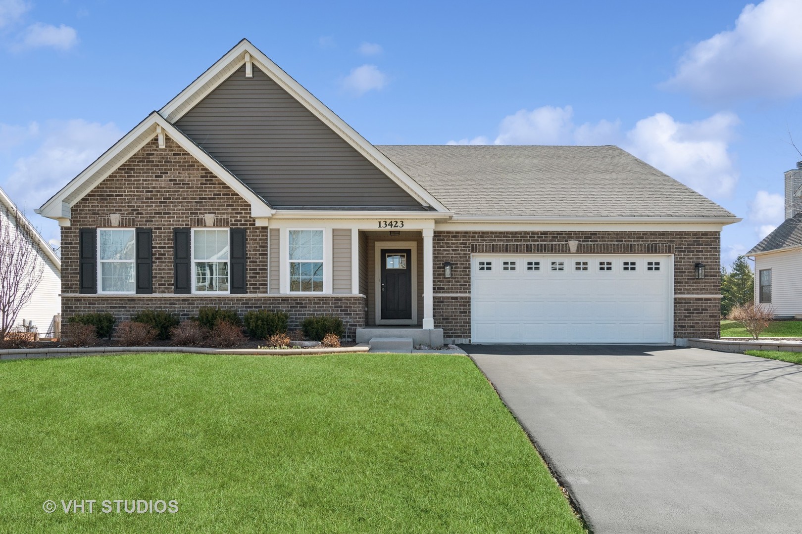 a front view of house with yard and green space