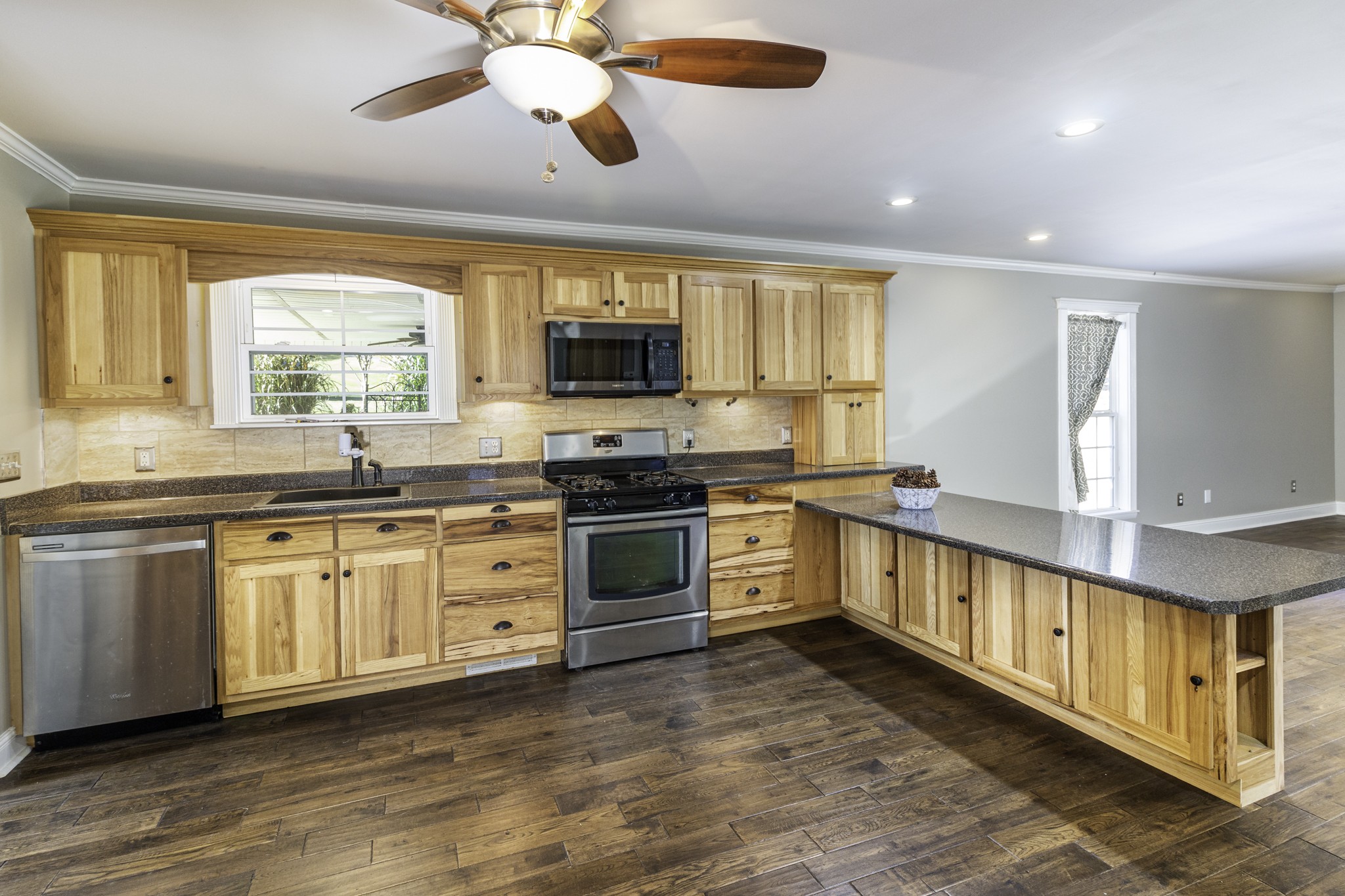 525 York Hollow Road Pulaski, TN 38478 - Photo 8 of 48 a kitchen with stainless steel appliances granite countertop a stove a sink and a microwave