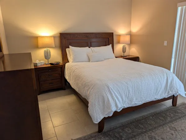 a bedroom with a bed and lamp