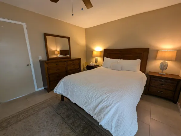 a bedroom with a bed and a tv