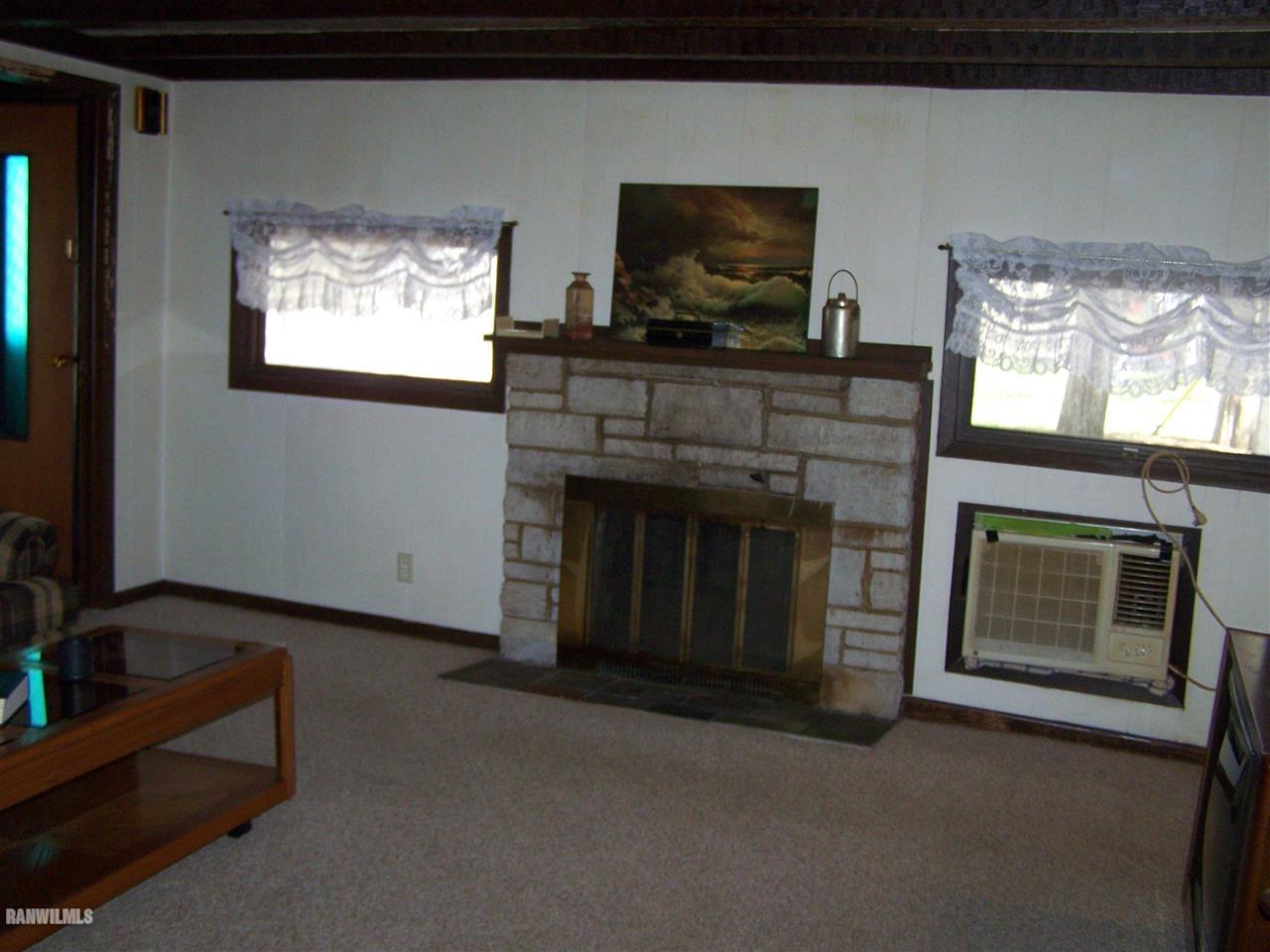 5919 Riverview Road Thomson, IL 61285 - Photo 7 of 12 a living room with furniture a flat screen tv and a fireplace
