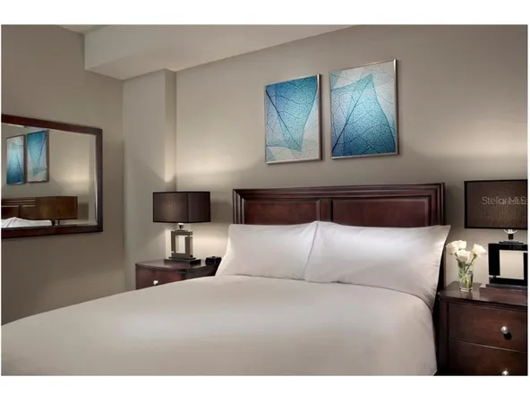 a bedroom with a bed and a tv