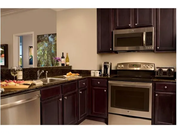a kitchen with a sink stove and microwave