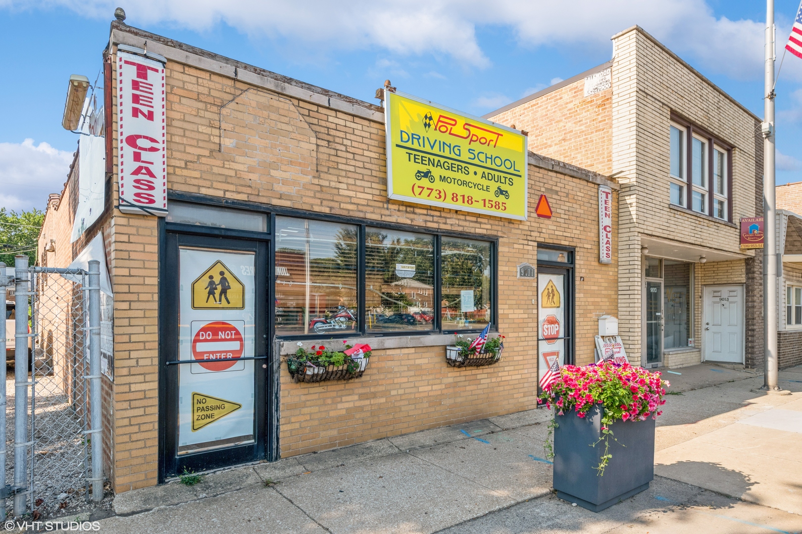 a front view of multi story building with retail shops