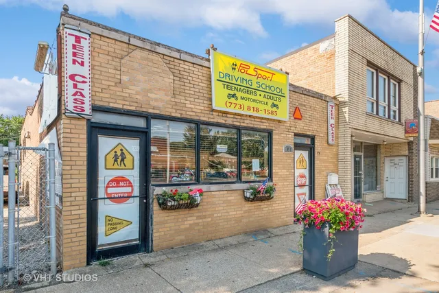 a front view of a multi story building with retail shops