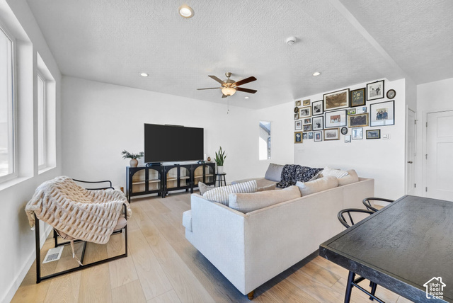 428 Quartz Road Tooele, UT 84074 - Photo 7 of 35 Spacious living area featuring large windows, wood-finish flooring, recessed lighting, and a ceiling fan