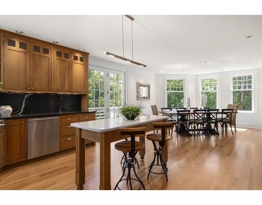 14 Byron Road Weston, MA 02493 - Photo 12 of 33 a kitchen with stainless steel appliances granite countertop a table chairs and a refrigerator
