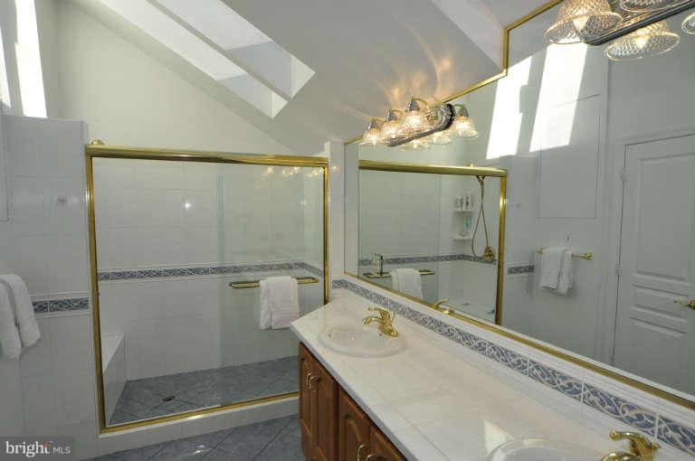 2260 Compass Point Lane Reston, VA 20191 - Photo 16 of 23 a bathroom with a granite countertop sink a mirror and shower