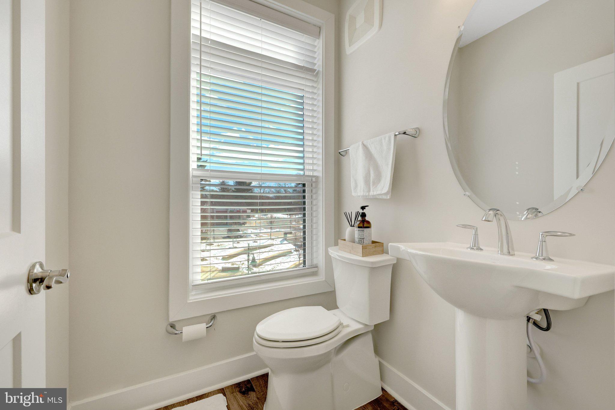 1694 Bandit Loop, Unit 17B Reston, VA 20190 - Photo 16 of 46 a bathroom with a toilet sink and mirror