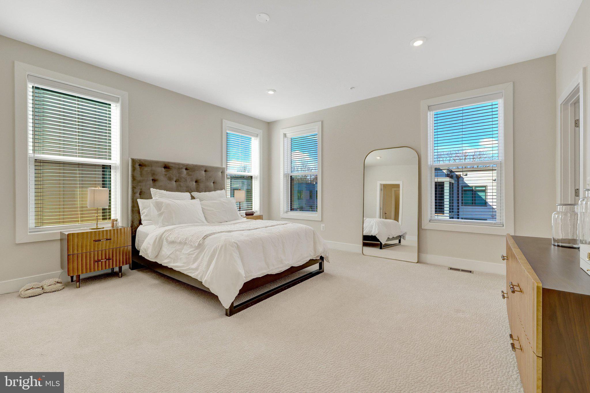 1694 Bandit Loop, Unit 17B Reston, VA 20190 - Photo 20 of 46 a bedroom with a bed couch and windows