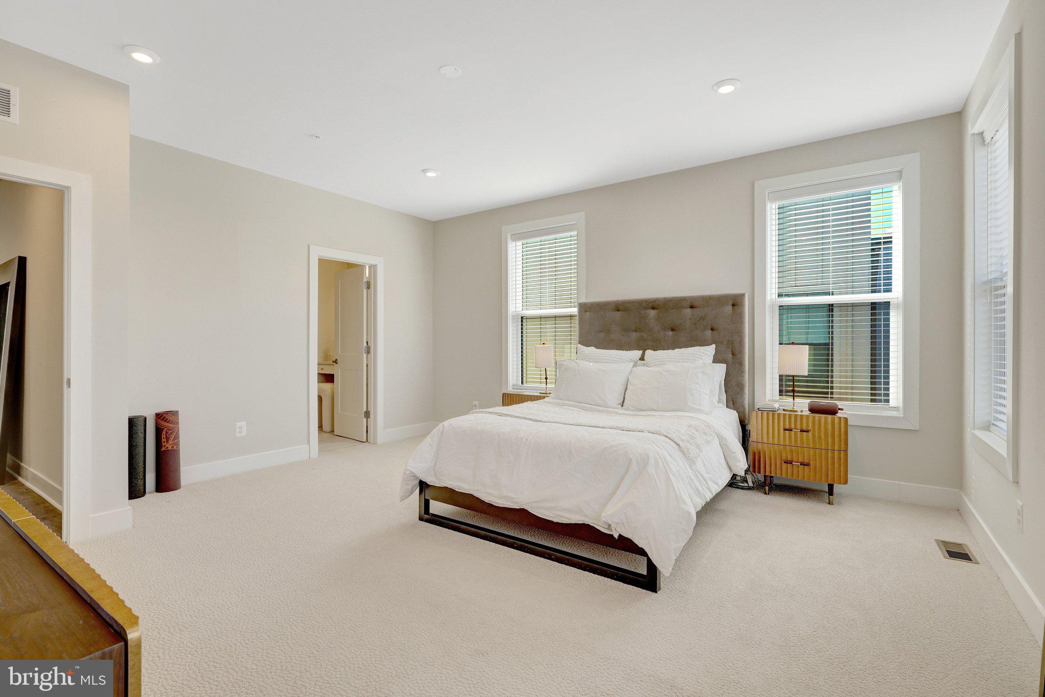1694 Bandit Loop, Unit 17B Reston, VA 20190 - Photo 21 of 46 a spacious bedroom with a bed and a couch