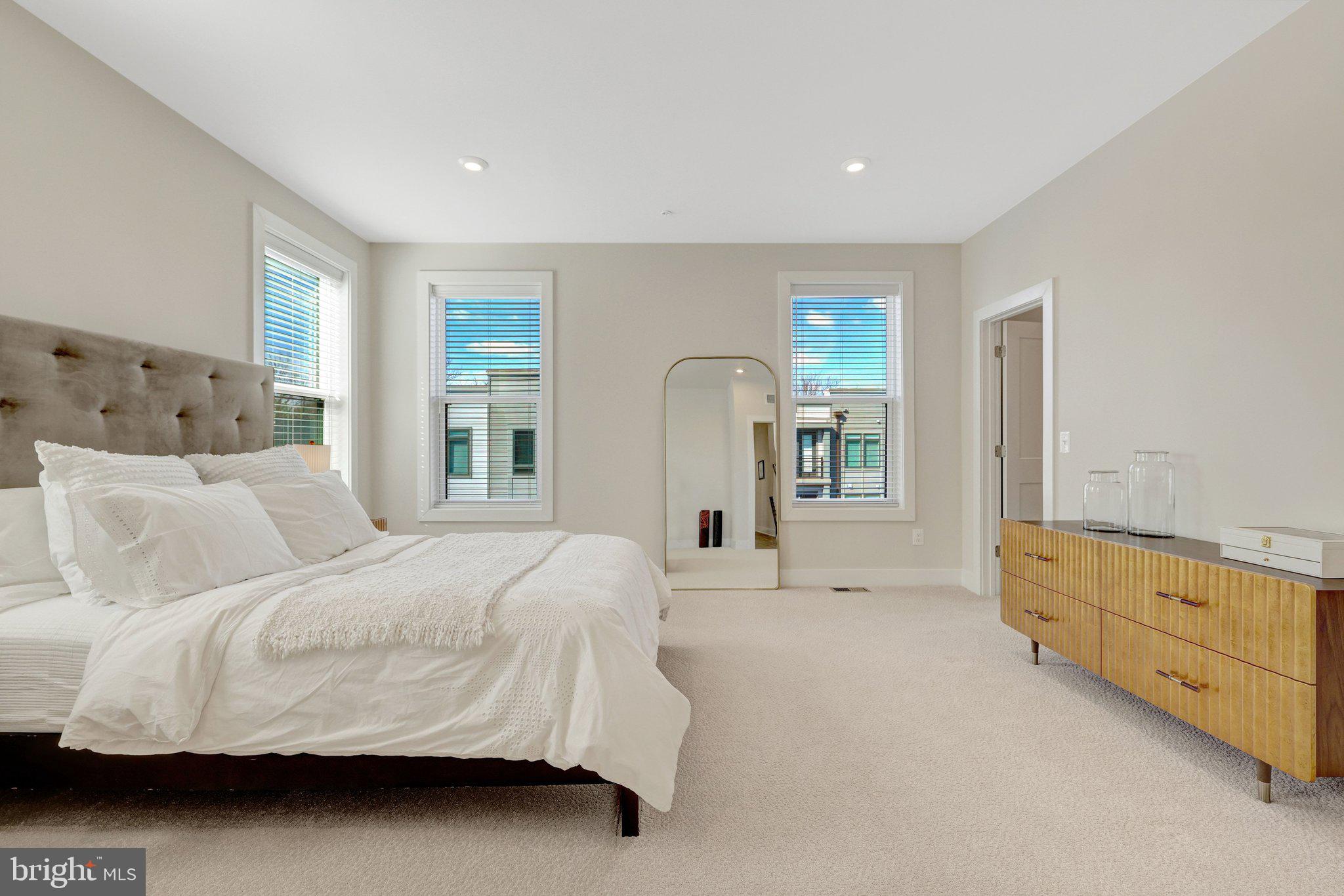 1694 Bandit Loop, Unit 17B Reston, VA 20190 - Photo 22 of 46 a bedroom with a bed and a dresser